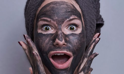 woman with charcoal face mask on