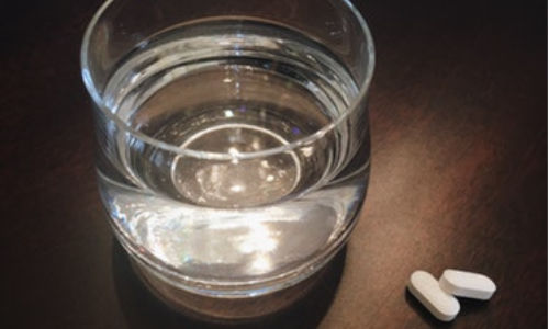 melatonin and glass of water