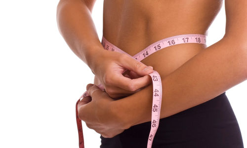 woman measuring waist weightloss