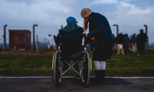 woman in wheelchair with caregiver