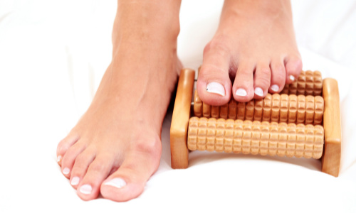 feet and wooden massager - self care tools