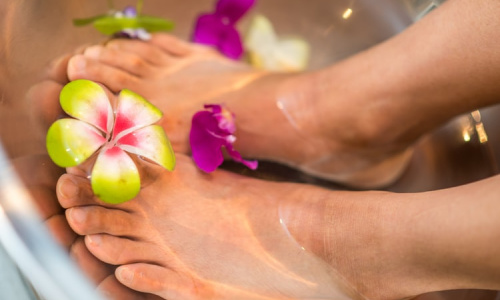 woman's feet covered in water in a foot spa
