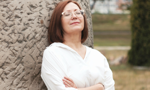 woman with arms crossed and eyes closed