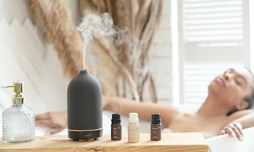 woman having bath with diffuser nearby